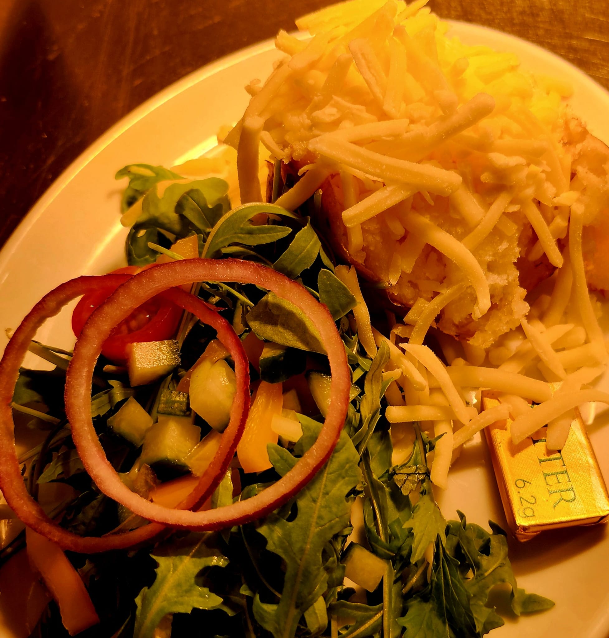 Loaded jacket potato with cheese and salad